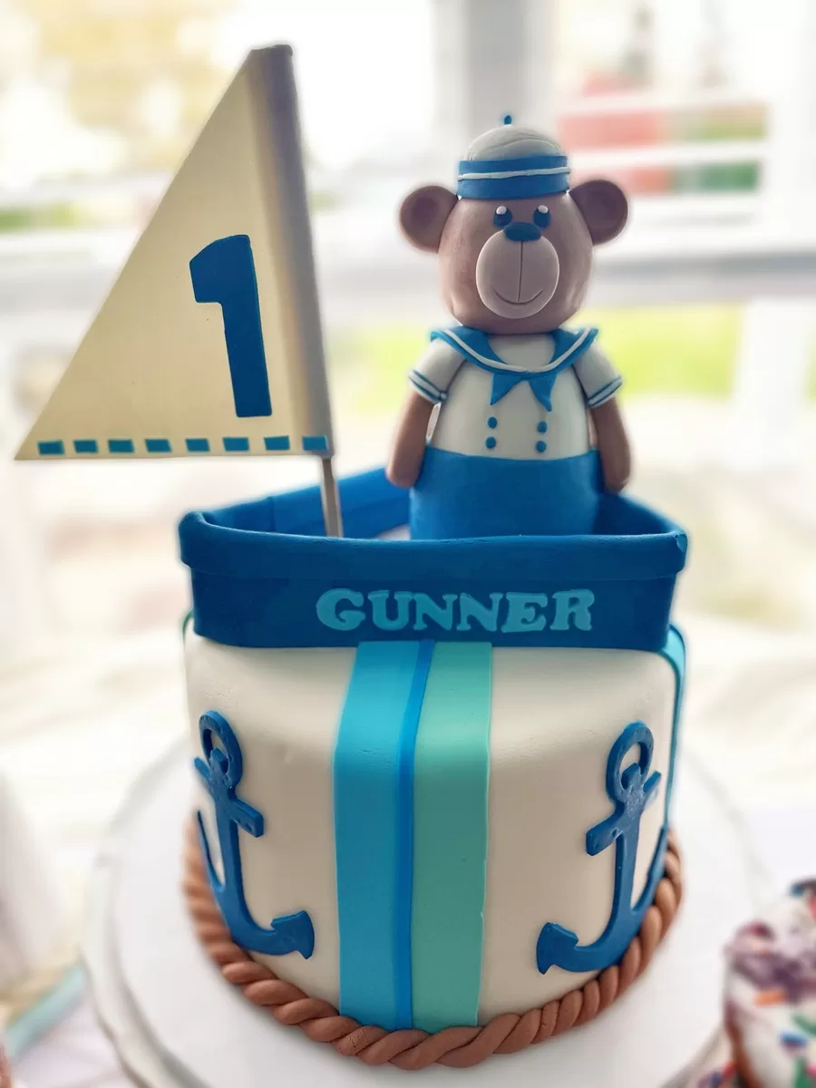 birthday cake with teddy bear dressed as sailor in a boat