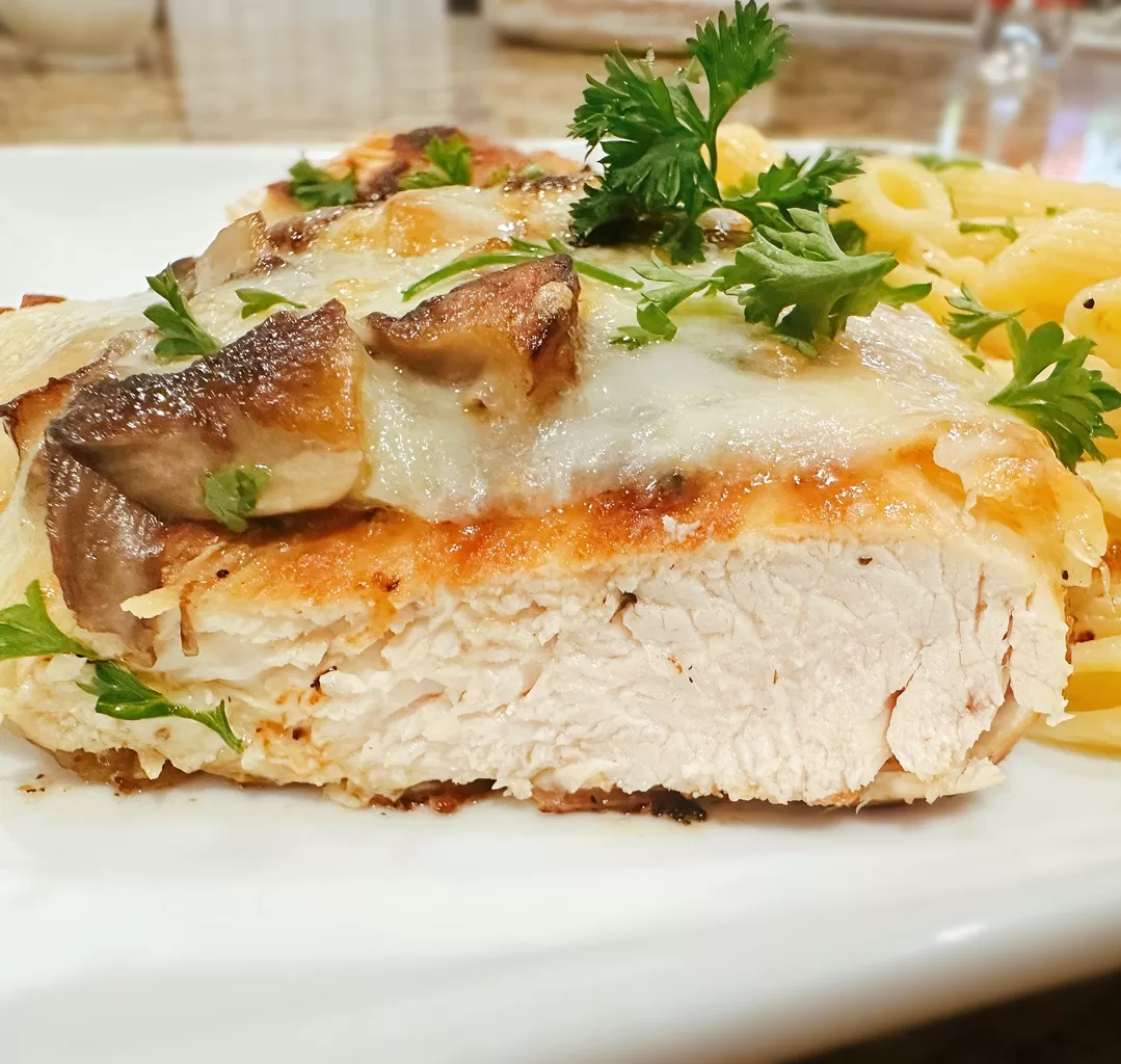 photo of smothered juicy chicken breast cut