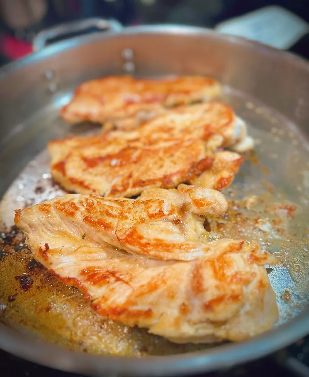 chicken browning in a pan