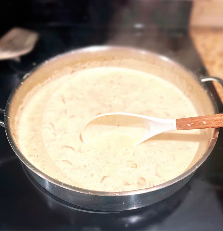 alfredo sauce simmering in a pan