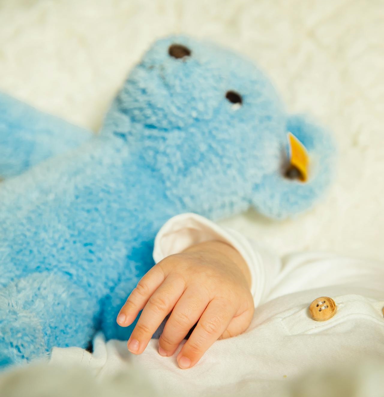 baby sleeping with teddy bear