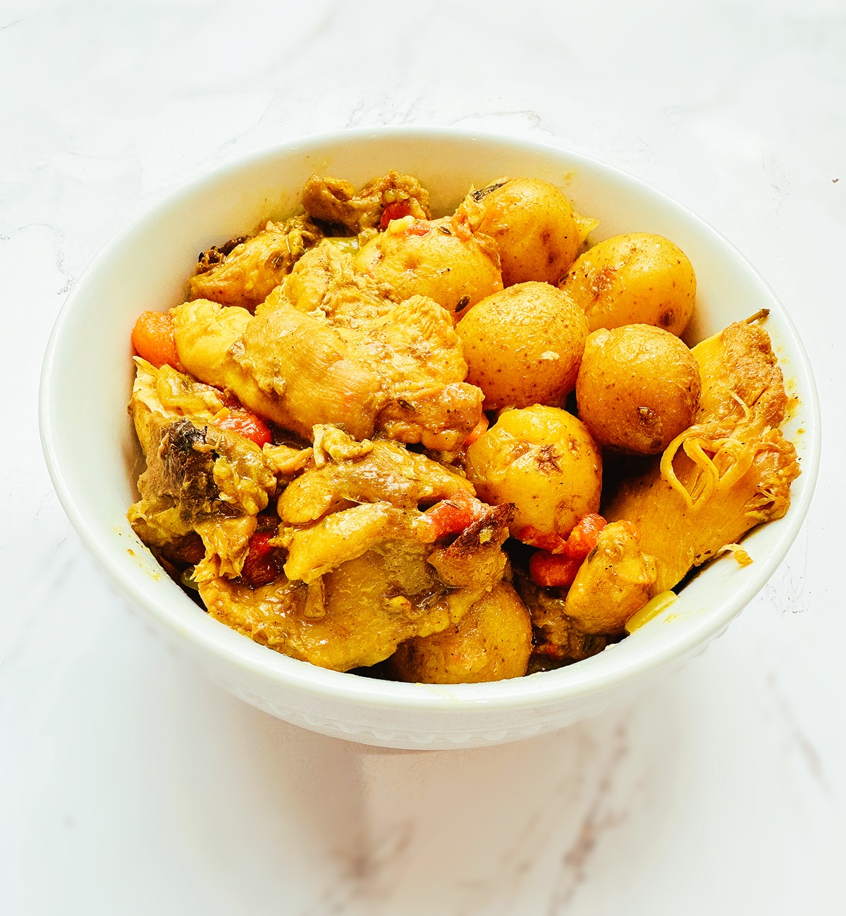 jamaican curry chicken in a white bowl