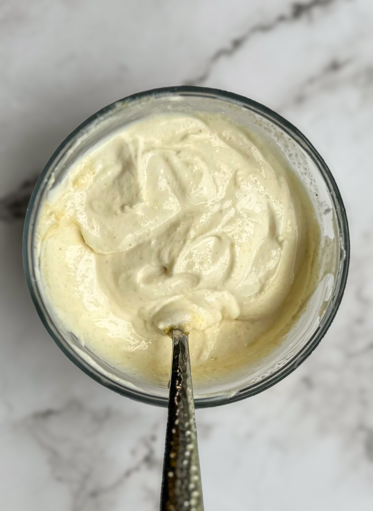 yogurt sauce for turkish pasta in a glass bowl