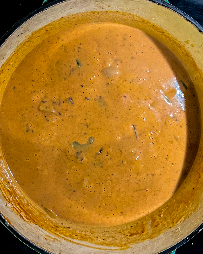 crab and shrimp seafood bisque simmering in a pot
