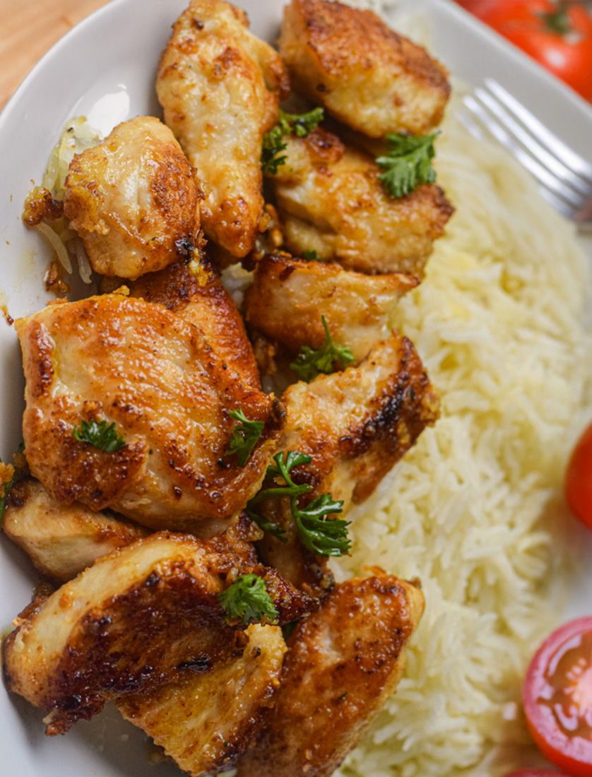 Garlic Butter Chicken Bites on a plate with rice