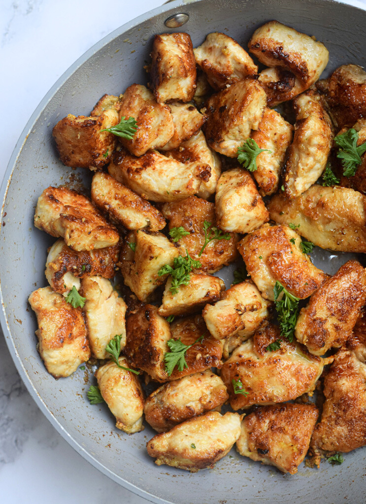 Garlic Butter Chicken Bites closeup in a white frying pan