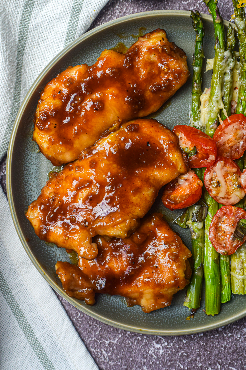 honey chicken closeup shot with asparagus on the side