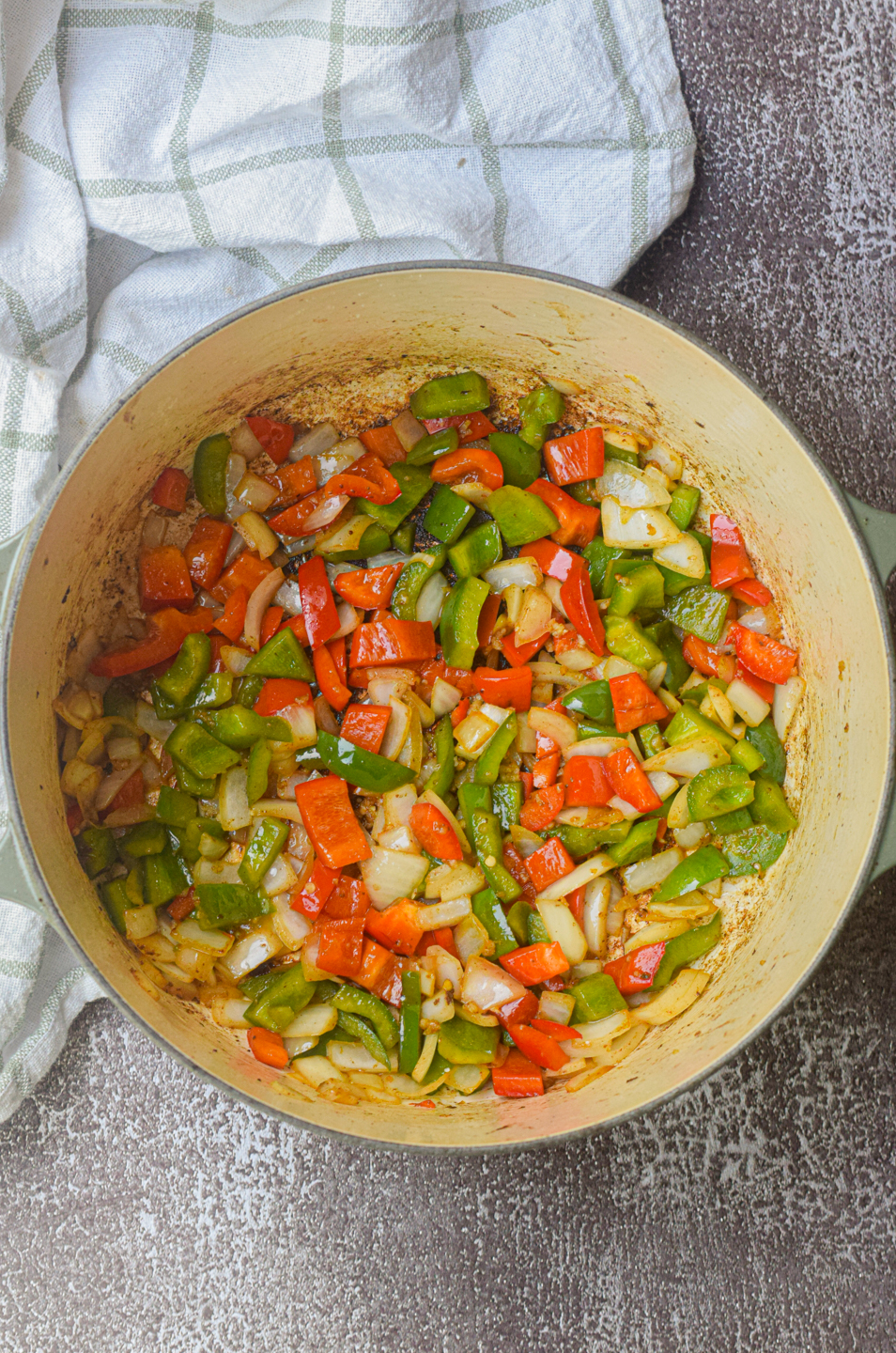 philly cheesesteak pasta ingredients cooking in dutch oven
