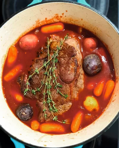 pot roast stew with vegetables in a dutch over