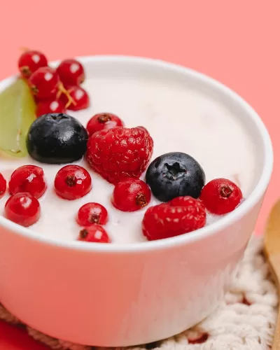 bowl of greek yogurt topped with raspberries and blueberries
