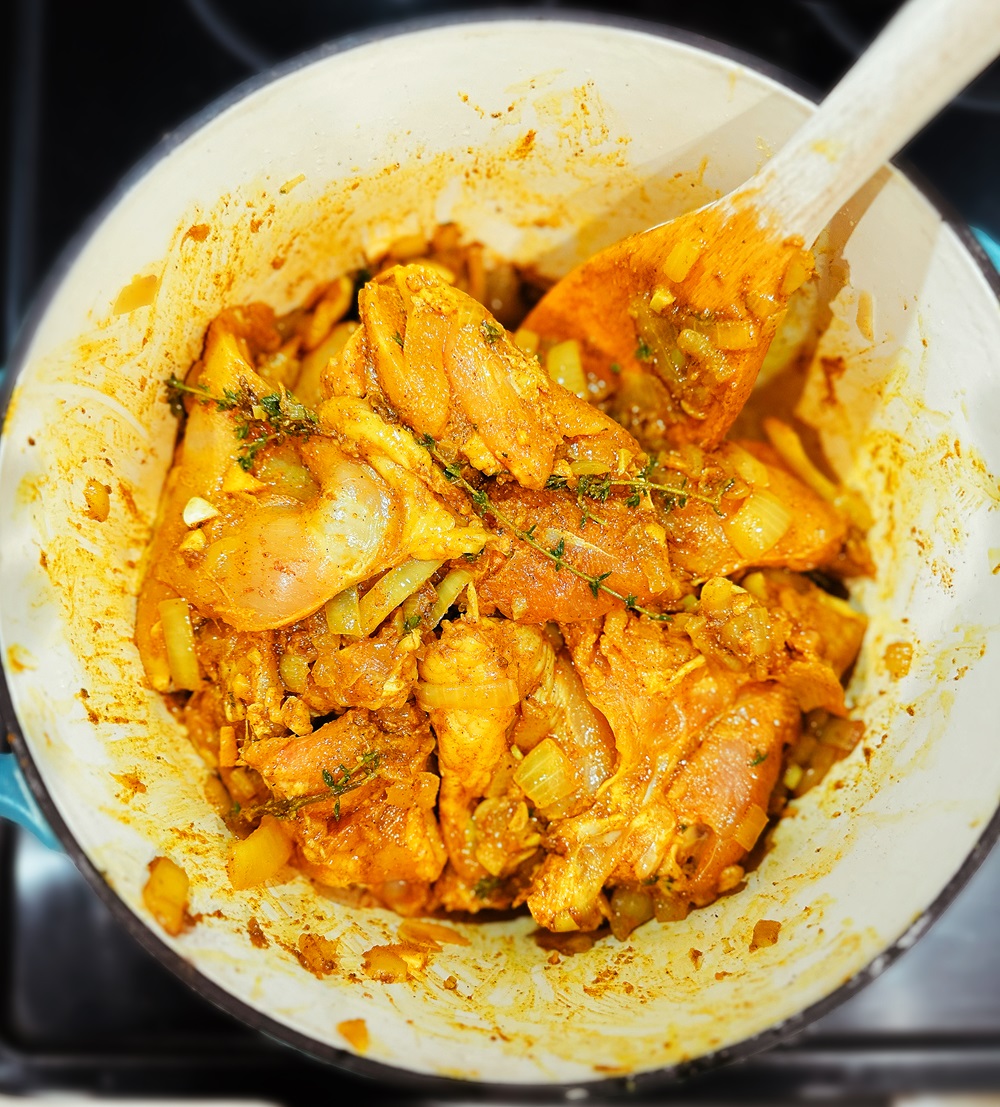 jamaican chicken curry simmering in a dutch oven
