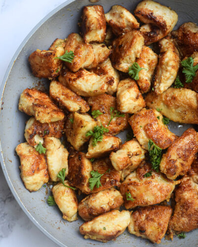 Garlic Butter Chicken Bites closeup in a white frying pan