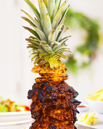 chicken al pastor on a skewer with a pineapple on top